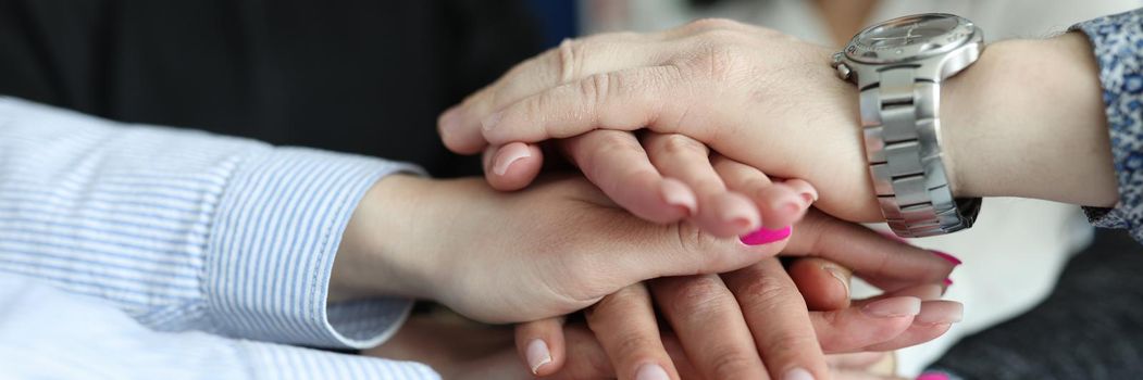 Young male and female hands close-up, successful teamwork. Employee support, partner network, management