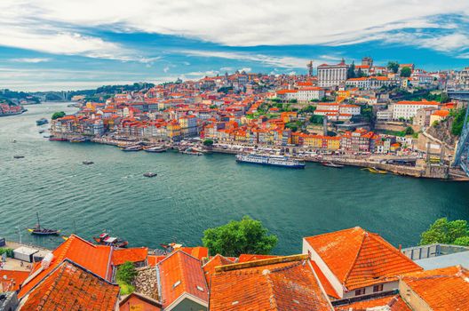 Aerial panoramic view of Porto Oporto city historical centre with Ribeira district colorful buildings houses on embankment of Douro River with fishing and touristic boats, Norte or Northern Portugal