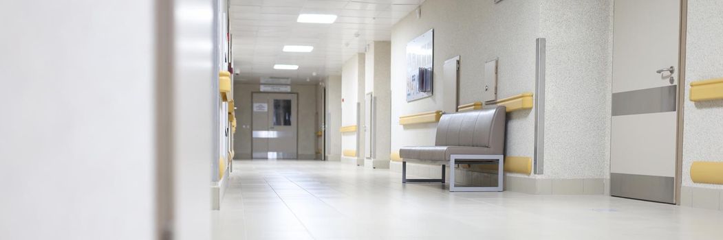 An empty corridor of a large building, a reception room in a hospital, close-up. Restrictions during a pandemic, lockdown. Floor nobody