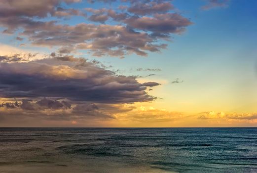 Beautiful colorful clouds over the sea. Amazing sky after sunset.