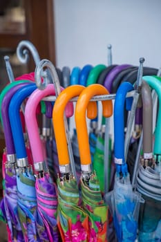 Day view of umbrellas with handles of different colors.  close-up