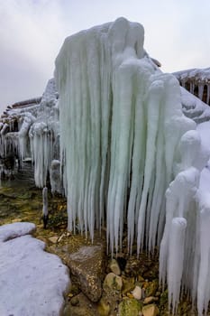 Beautiful big icicles over the old abandoned bridge