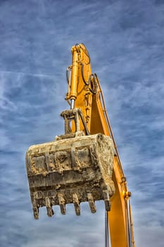 Bucket and manipulator of single excavator arm with hydraulic Hoses and cylinder in action. Close up