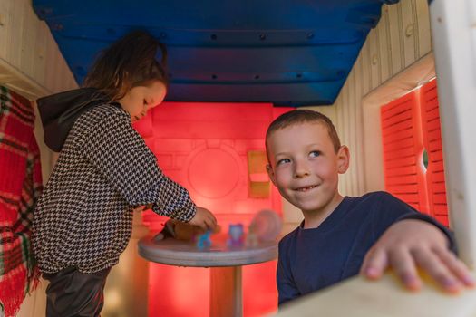 Children play in the children's house with toys