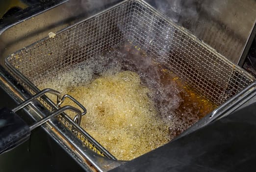 fryer for potatoes with fries with boiling oil. Concept fast food restaurant,  kitchen equipment