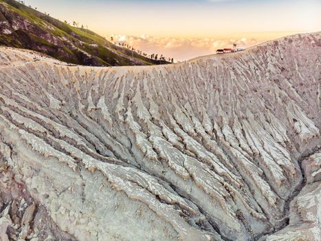 Aerial shot of the Ijen volcano or Kawah Ijen on the Indonesian language. Famous volcano containing the biggest in the world acid lake and sulfur mining spot at the place where volcanic gasses come from the volcano.