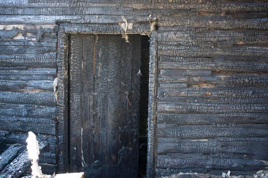 Black background. Burnt wooden Board texture. Burned scratched hardwood surface. Smoking wood plank background. Burned wooden grunge texture Space for text.