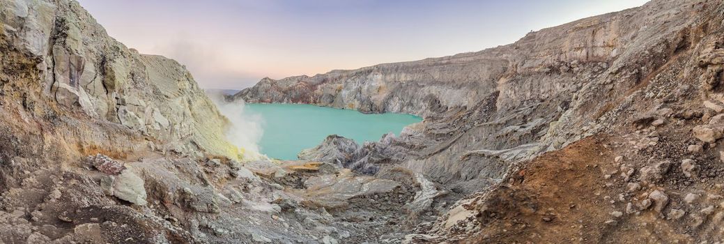 Panoramic shot of the Ijen volcano or Kawah Ijen on the Indonesian language. Famous volcano containing the biggest in the world acid lake and sulfur mining spot at the place where volcanic gasses come from the volcano.