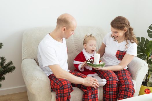 Child girl dressed in christmas dress with cochlear implants having fun at home - hearing aid and innovating technologies for treatment deafness