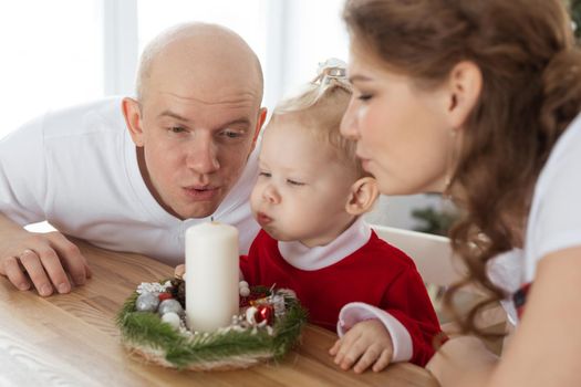 Baby child with hearing aid and cochlear implant having fun with parents in christmas room. Deaf and health