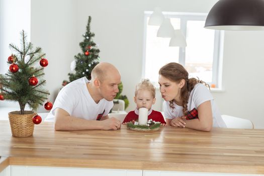 Baby child with hearing aid and cochlear implant having fun with parents in christmas room. Deaf and health