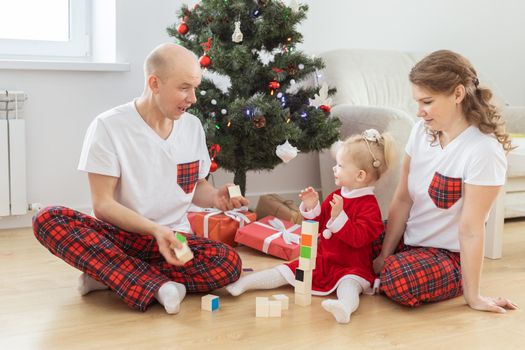 Toddler child with cochlear implant decorating christmas tree deafness and innovating medical technologies for hearing aid