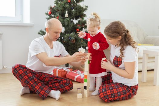 Toddler child with cochlear implant decorating christmas tree deafness and innovating medical technologies for hearing aid