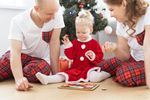 Toddler child with cochlear implant decorating christmas tree deafness and innovating medical technologies for hearing aid