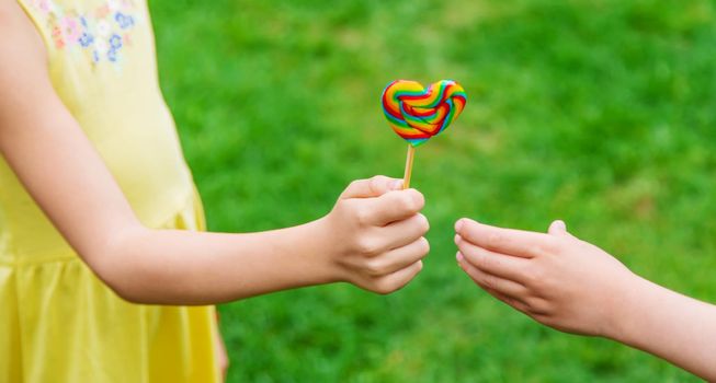 Lollipops in the hands of children. Selective focus. nature.