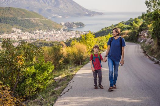 Happy family on the background of Panoramic view of the city of Budva, Montenegro. Beautiful view from the mountains to the Adriatic Sea.