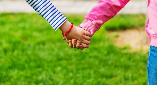 children holding hands in the park.selective focus.kids