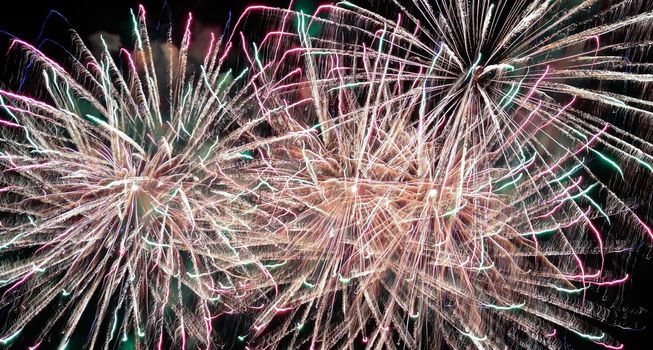 Colorful fireworks of various colors over night sky