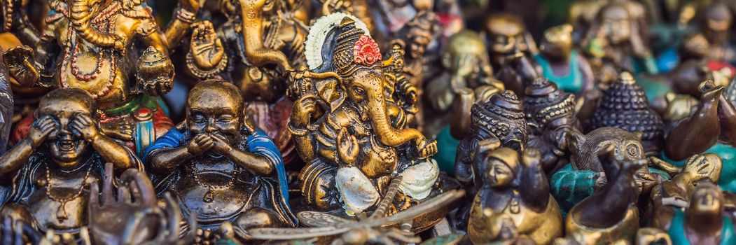 Typical souvenir shop selling souvenirs and handicrafts of Bali at the famous Ubud Market, Indonesia. Balinese market. Souvenirs of wood and crafts of local residents. BANNER, LONG FORMAT