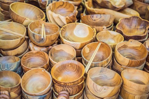 Typical souvenir shop selling souvenirs and handicrafts of Bali at the famous Ubud Market, Indonesia. Balinese market. Souvenirs of wood and crafts of local residents.
