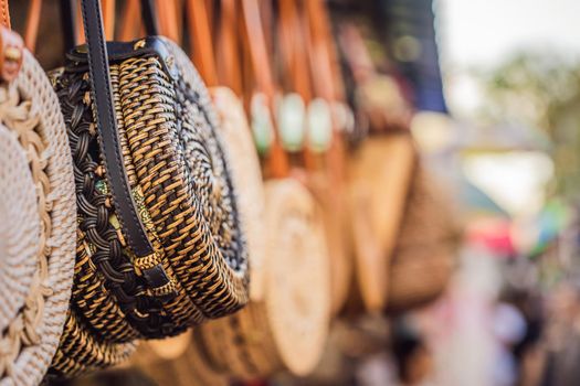 Typical souvenir shop selling souvenirs and handicrafts of Bali at the famous Ubud Market, Indonesia. Balinese market. Souvenirs of wood and crafts of local residents.