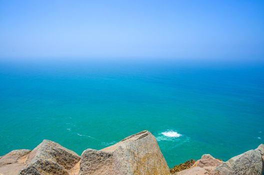 Cabo da Roca or westernmost point of continental Europe and Eurasia, view of Atlantic Ocean turquoise water and endless horizon from Cape Roca rocks and cliffs, Sintra municipality, Portugal