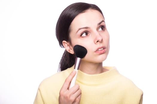 attractive young woman doing makeup. High quality photo