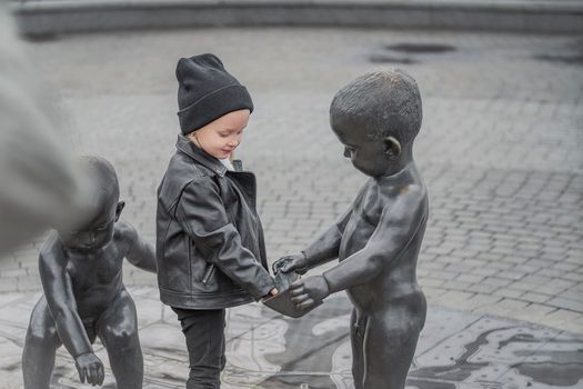 little girl is playing in the city square