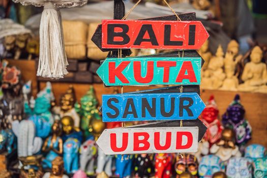 Typical souvenir shop selling souvenirs and handicrafts of Bali at the famous Ubud Market, Indonesia. Balinese market. Souvenirs of wood and crafts of local residents.