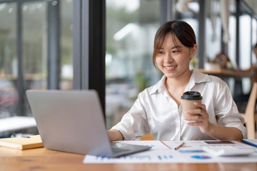businesswoman typing on laptop report analyzing work results, female executive doing paperwork at workplace using computer online software for data analysis.