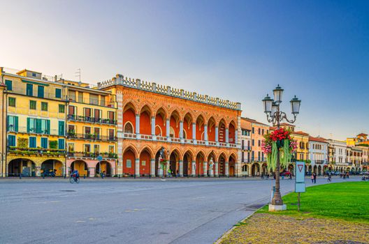 Padua cityscape with Palazzo Loggia Amulea palace neogothic style building and street lights on Piazza Prato della Valle square in historical city centre, Padova town, Veneto Region, Italy