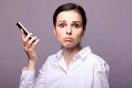 woman in a white shirt and glasses communicates on the phone. High quality photo