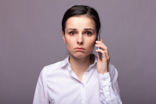 woman in a white shirt and glasses communicates on the phone. High quality photo