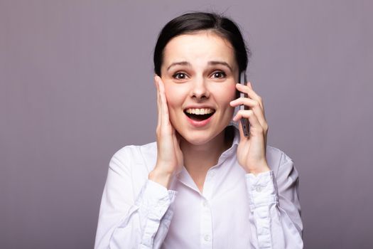 woman in a white shirt and glasses communicates on the phone. High quality photo