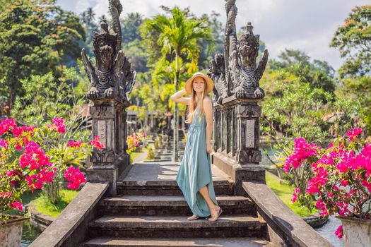 Young woman tourist in Taman Tirtagangga, Water palace, Water park, Bali Indonesia.