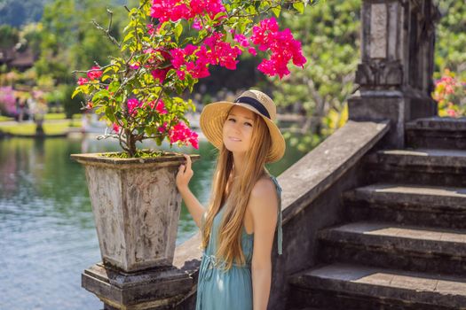 Young woman tourist in Taman Tirtagangga, Water palace, Water park, Bali Indonesia.