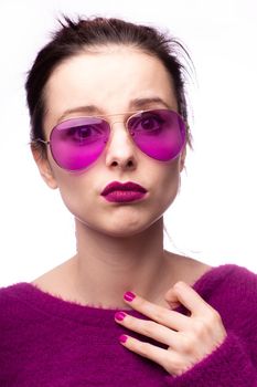 woman in purple sweater, purple glasses with purple lipstick on her lips. High quality photo