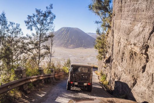 View from the inside of an offroad car riding down the road at the Bromo Tengger Semeru National Park on the Java Island, Indonesia. One of the most famous volcanic objects in the world. Travel to Indonesia concept.