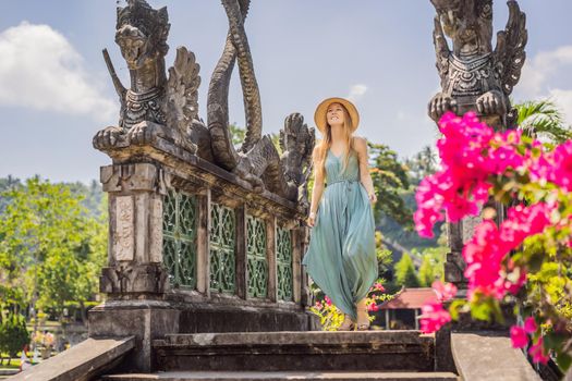 Young woman tourist in Taman Tirtagangga, Water palace, Water park, Bali Indonesia.
