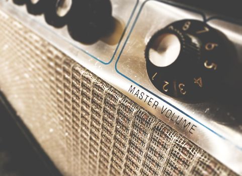 Close-up view of the knobs of an amplifier for adjusting the sound of stringed musical instruments. Concert and live performance. Music and entertainment