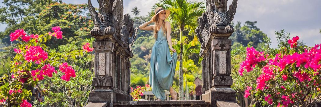 Young woman tourist in Taman Tirtagangga, Water palace, Water park, Bali Indonesia. BANNER, LONG FORMAT