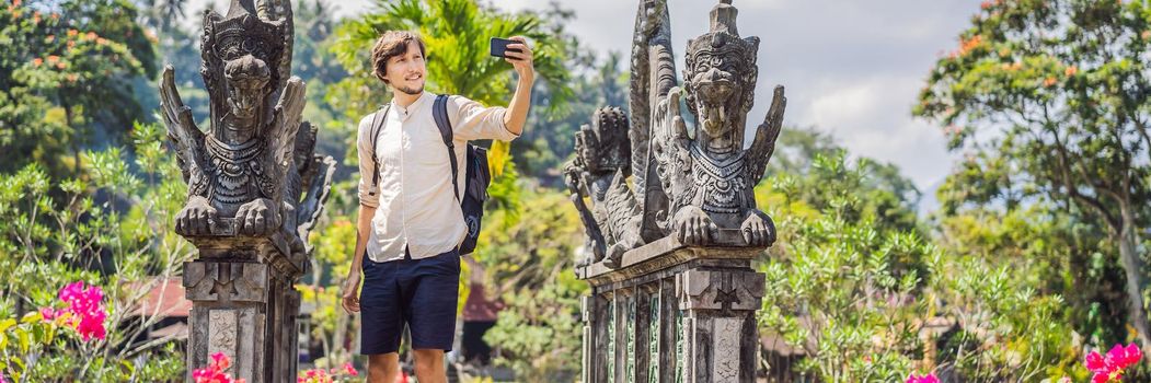 Young man tourist in Taman Tirtagangga, Water palace, Water park, Bali Indonesia. BANNER, LONG FORMAT