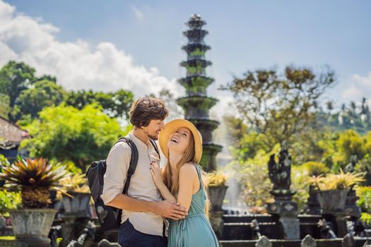 Happy loving couple in Taman Tirtagangga, Water palace, Water park, Bali Indonesia. Honeymoon in Bali.