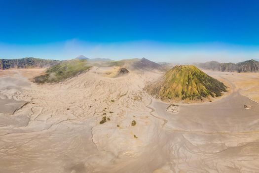 Panoramic Aerial shot of the Bromo volcano and Batok volcano at the Bromo Tengger Semeru National Park on Java Island, Indonesia. One of the most famous volcanic objects in the world. Travel to Indonesia concept.