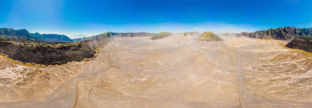 Panoramic Aerial shot of the Bromo volcano and Batok volcano at the Bromo Tengger Semeru National Park on Java Island, Indonesia. One of the most famous volcanic objects in the world. Travel to Indonesia concept.