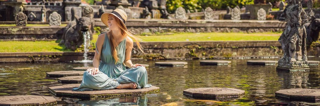 Young woman tourist in Taman Tirtagangga, Water palace, Water park, Bali Indonesia. BANNER, LONG FORMAT