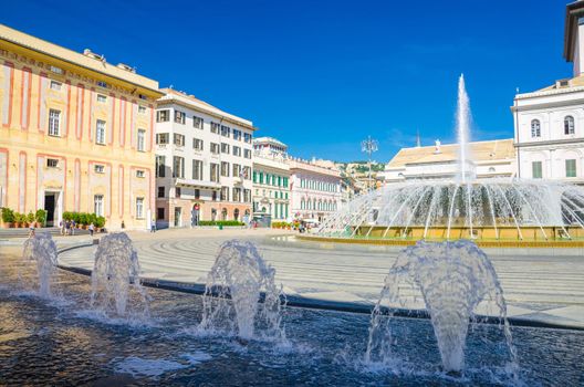 Piazza Raffaele De Ferrari square with fountain, Palazzo Ducale Doge's Palace and Teatro Carlo Felice theatre building in historical centre of old city Genoa Genova with blue sky, Liguria, Italy