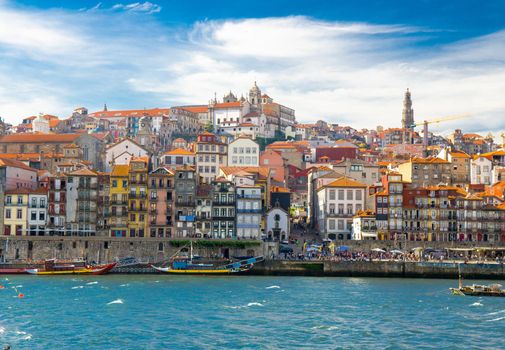 View of Old Porto, Oporto city, colorful Ribeira traditional wine boats in Douro river from Vila Nova de Gaia, Portugal