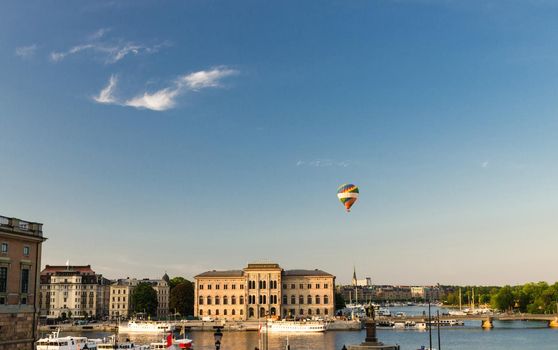 National Museum of Fine Arts Nationalmuseum building located on peninsula Blasieholmen in city centre with colorful hot air balloon in blue sky view from old town quarter Gamla Stan, Stockholm, Sweden