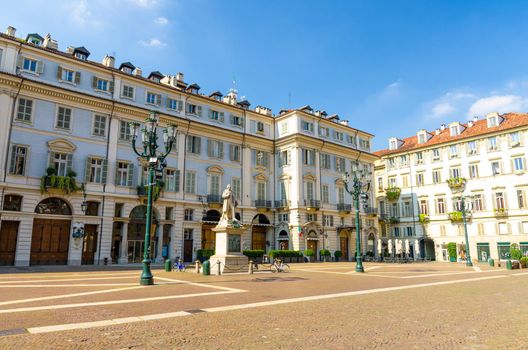 Teatro Carignano theatre building, Vincenzo Gioberti monument and street lamps on Piazza Carignano square in historical centre of Turin Torino city in beautiful summer day, Piedmont, Italy